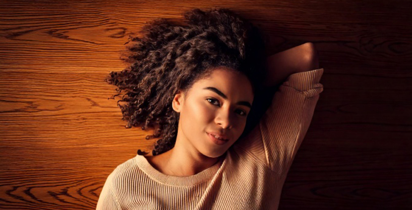 Young woman content lounging on radiant heated wood floors